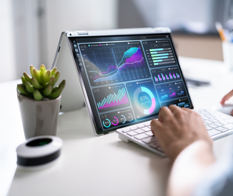 A professional analysing interactive data dashboards on a laptop showing charts, KPIs and performance metrics, symbolising business intelligence, marketing analytics, and data visualisation for informed enterprise decision-making.
