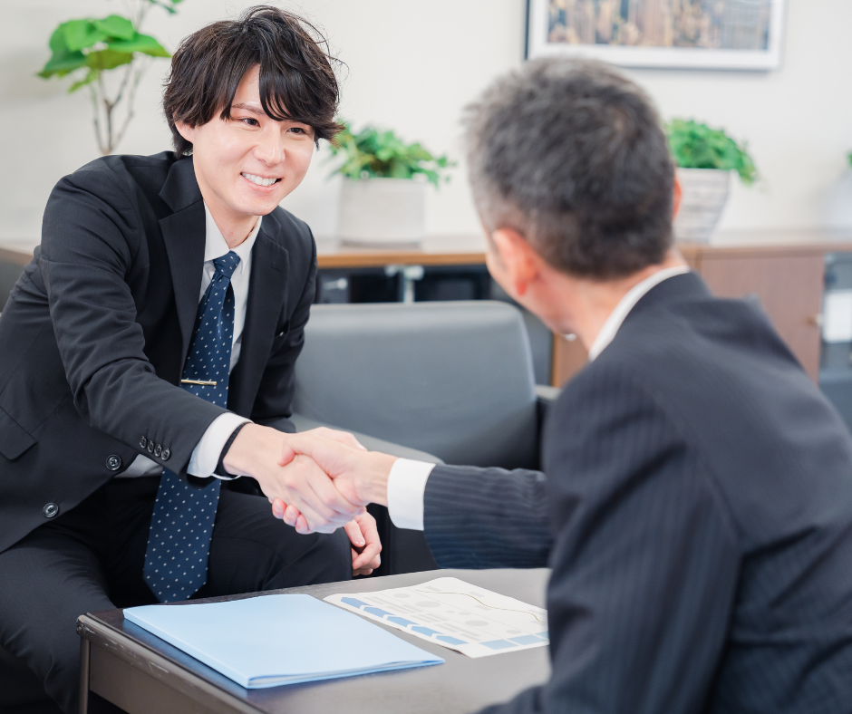 Business professionals shaking hands during a formal meeting, representing trusted enterprise partnerships, relationship-driven decision-making, and successful commercial collaboration in a professional business environment.