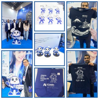 Acumori mascot merchandise collection displayed at Japan IT Week 2026, including branded t-shirts, keychains, figurines, and visitor interactions at the Acumen Intelligence booth.
