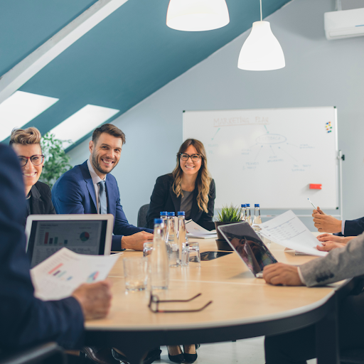 Business team meeting discussing data reports and strategy in modern office conference room
