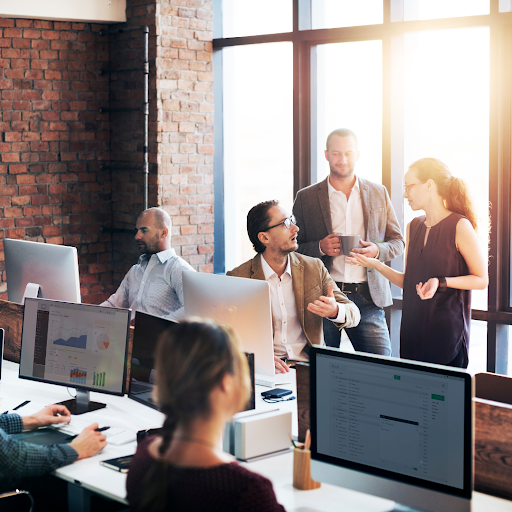 A modern B2B marketing and sales team collaborates in an office environment, using campaign data and digital insights to support business growth.