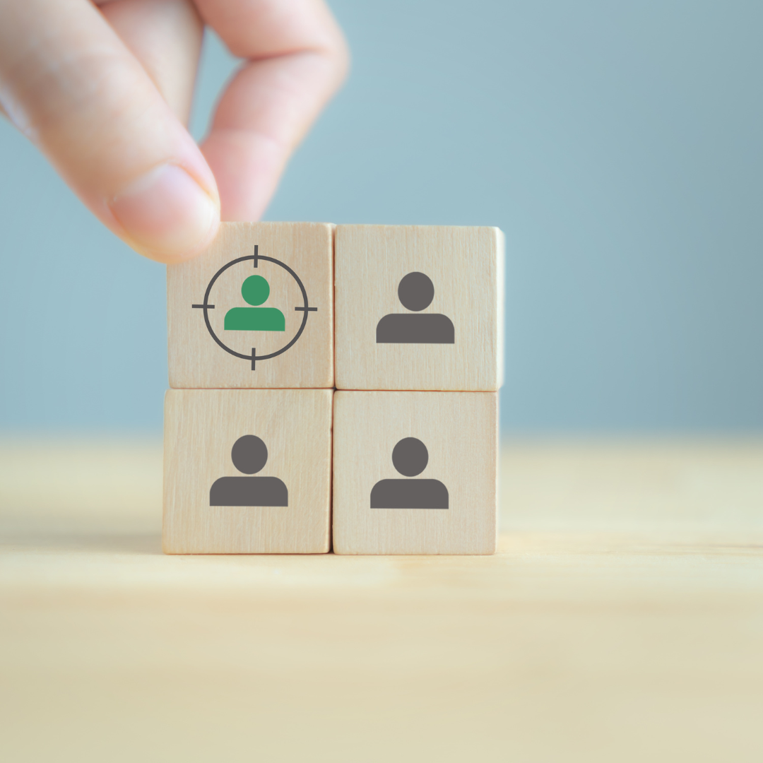 hand placing wooden block with target audience icon for customer segmentation strategy